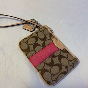 Coach signature wristlet with a pink accent